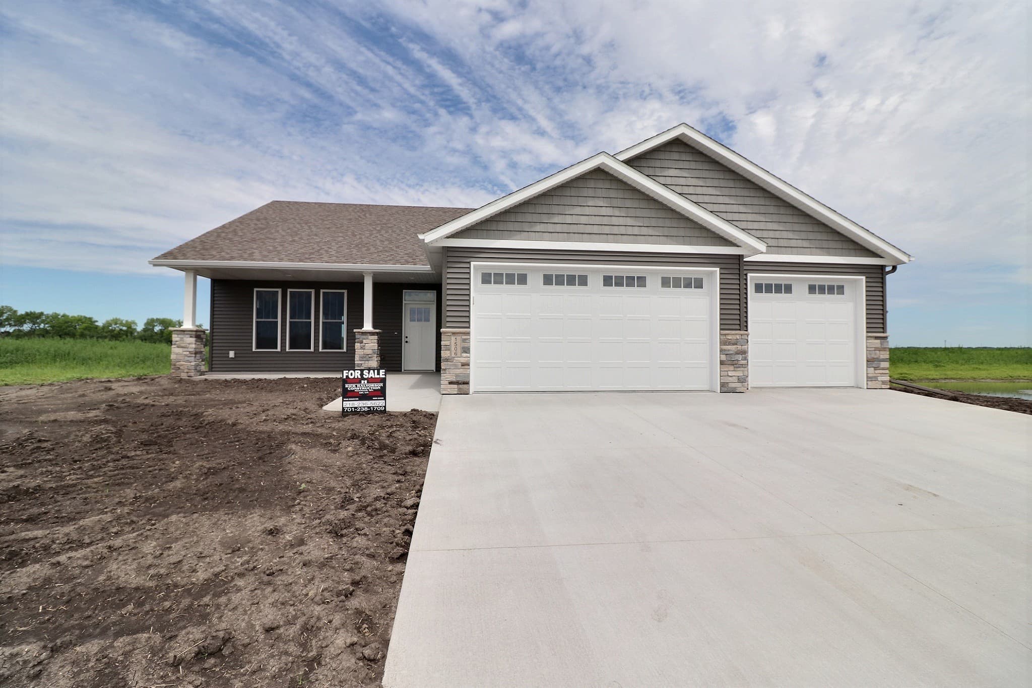 Front exterior of a new RHC home with covered porch and craftsman gable