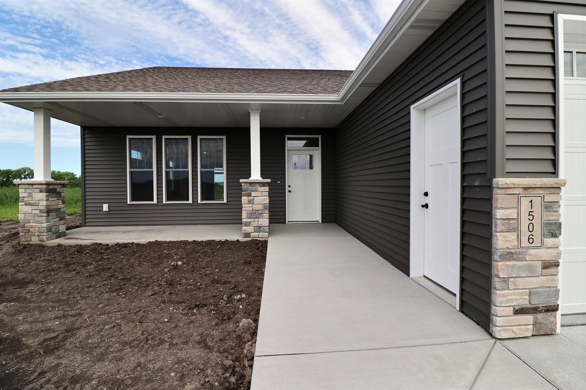 Front entry walkway and porch of a newly built RHC home