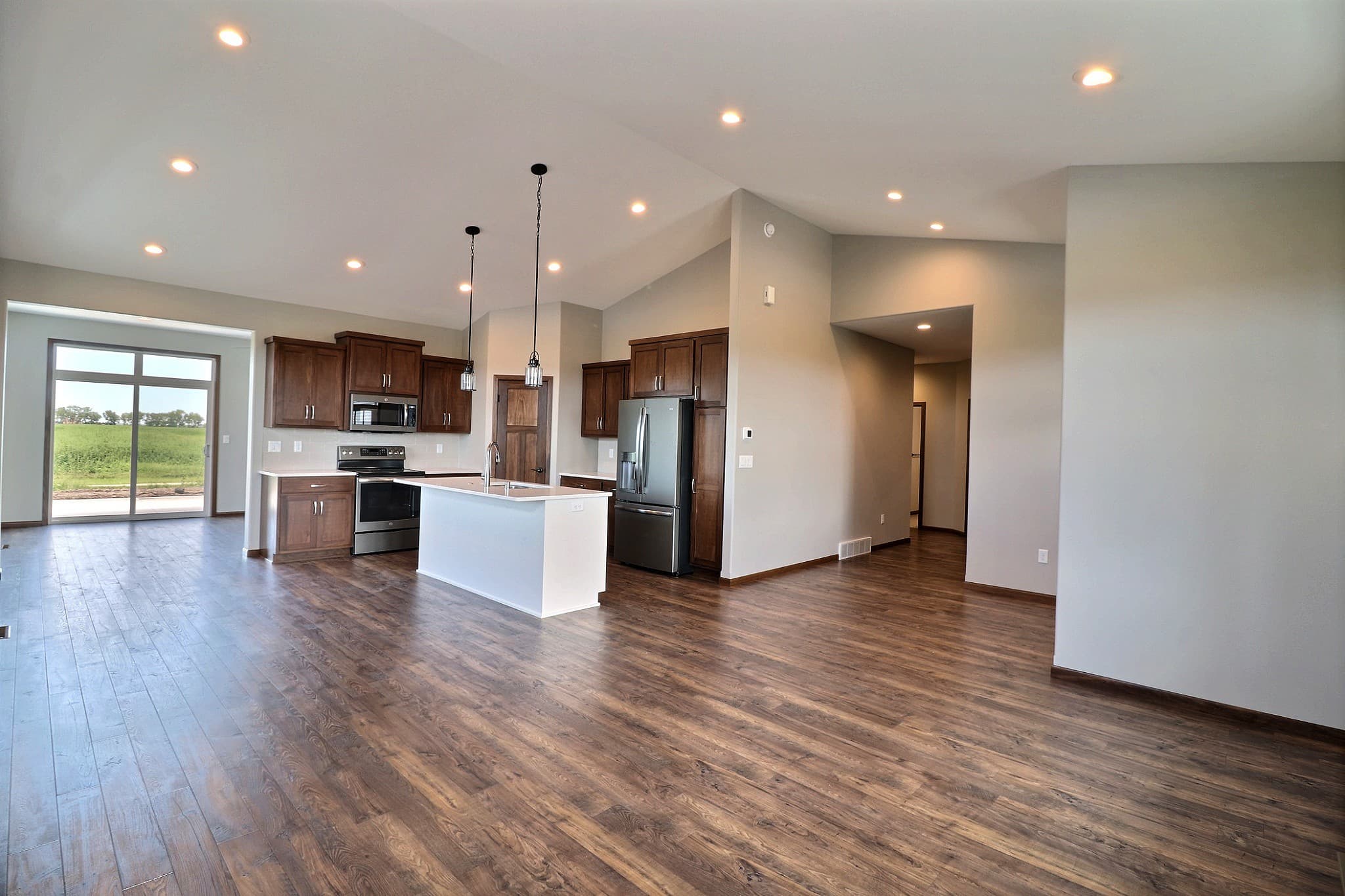 Custom kitchen with center island, pendant lighting and cherry cabinetry